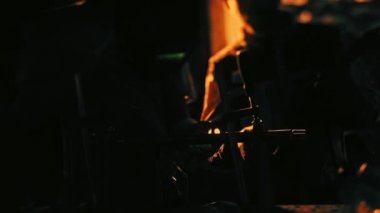 Close up of worker silhouette in the dark workshop standing near machine tool with bright light behind him. Stock footage. Male mechanic with professional equipment.