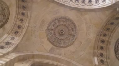 Bottom view of a beautiful ceiling of the european cathedral, architecture concept. Action. Rotating ceiling of historic building.