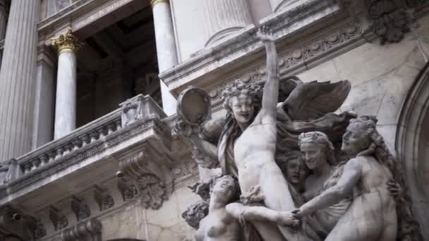 The facade of the building with different decorative architectural elements. Action. Detail of sculpture with angels, religion and architecture concept. — Stock Video