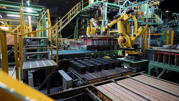 Plant for production of ceramic building blocks, professional technology. Stock footage. Working machinery and many rows of raw construction blocks on a conveyor belt. — ストック写真