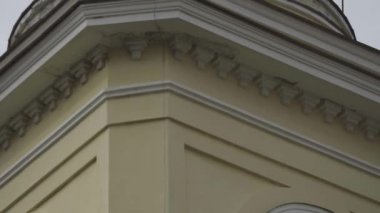 Kule cephesine yakın çekim ve kilise kubbesine çapraz geçiş. Stok görüntüleri. Bulutlu gökyüzünün arka planında Kilisenin altın kubbesinde güzel haçlar yükselir.