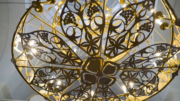 Beautiful gilded chandelier in Church. Stock footage. Panikadilo is main lamp of temple and symbol of Heavenly Church. Openwork patterns Church chandeliers with candles look divine — Stock Photo, Image