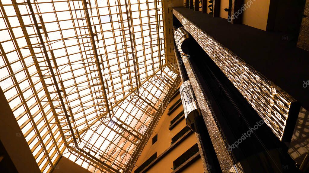 Futuristic Elevator in beautiful building. Stock footage. Modern Elevator design in beautiful light building with high Windows and warm lighting