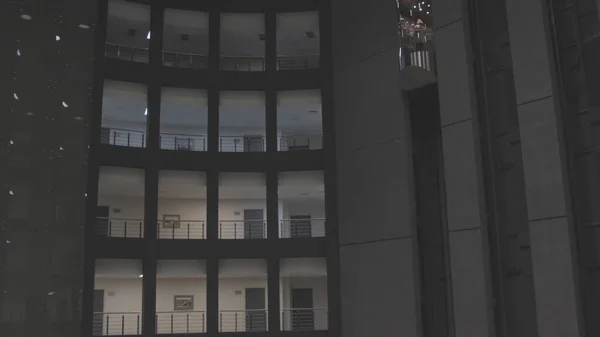Mulher se levanta no elevador. Estoque. Mulher sobe em vidro moderno Elevador em complexo residencial de vários andares. Elevador de vidro dentro do complexo residencial — Fotografia de Stock