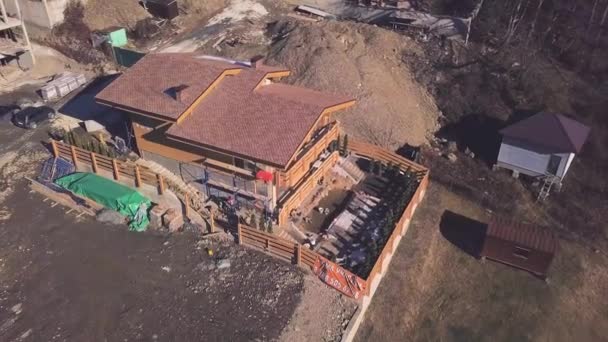 Top view of cottage under construction in country. Clip. Buildings in suburbs of private houses. Construction of private cottage on outskirts of city near forest — Stock Video