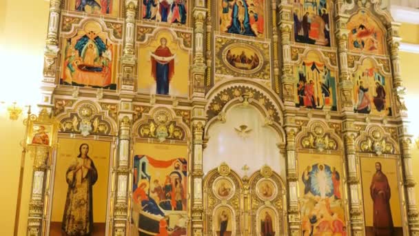 Russia - Moscow 20.04.20: View inside of the Orthodox church with gold iconostasis showing biblical stories, religion, architecture and faith concept. Stock footage. Close up of icons inside the — Stock Video