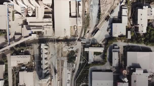 Aerial top view of buildings and materials warehouse in the industrial city zone from above. Stock footage. Many roofs of buildings, plants and warehouses at urban industrial zone. — Stock Video