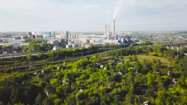 Top view of citys industrial district in summer. Stock footage. Industrial plants, businesses and warehouses located in suburbs in summer — Stock Video