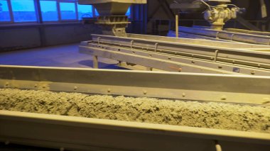 Toz çimento ile taşıma bandını kapatın. Stok görüntüleri. İnşaat malzemeleri üretim fabrikasının üretim hattında çimento tozu, ağır sanayi konsepti..