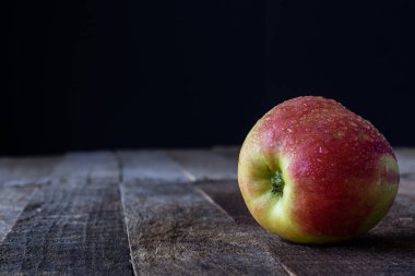 Tahta bir masada elma.