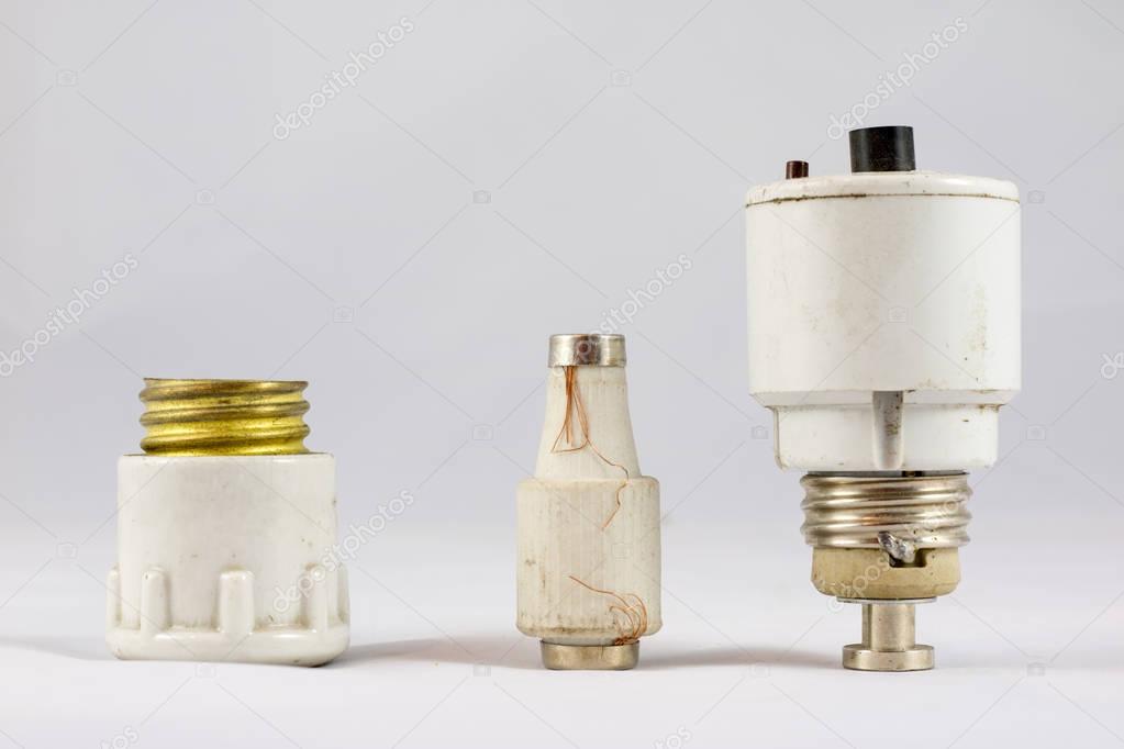 Old ceramic electric fuses on white isolated background