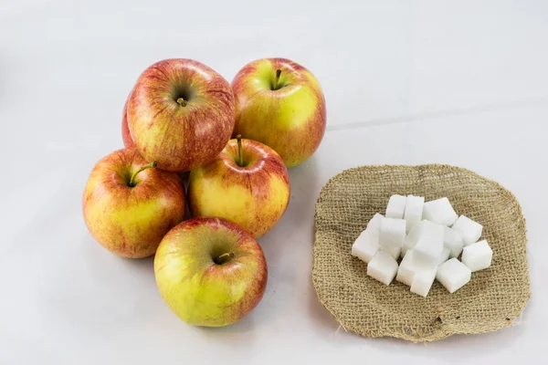 Tasty apples, pears and sugar in diced jute with isolated backgr