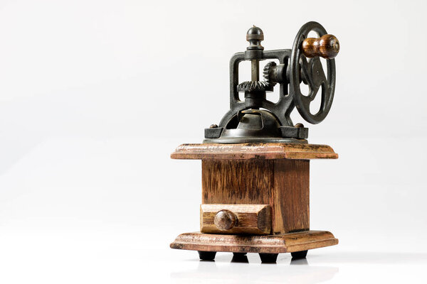 Old stylish grinder for grinding tasty coffee on white isolated 