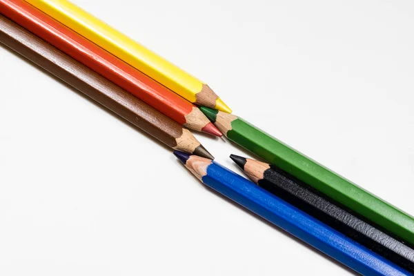 Cute baby pencil crayons on a white table. Isolated background. — Stock Photo, Image