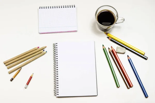 Café e caderno de esboços para desenhos. Mesa branca. Retrocesso isolado — Fotografia de Stock