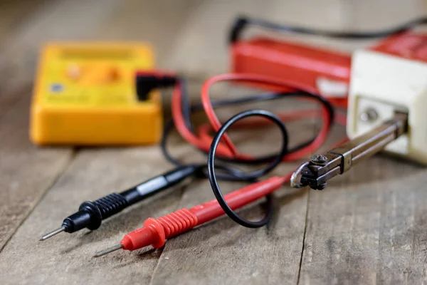 Electronic workshop. Electric meter and soldering iron. — Stock Photo, Image