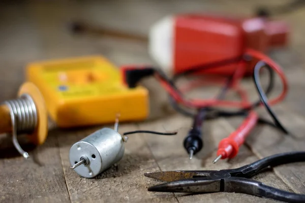 Electronic workshop. Electric meter and soldering iron. — Stock Photo, Image