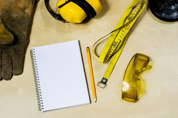 Casco, protección auditiva, herramientas, mesa de taller. Equipo de seguridad — Foto de Stock