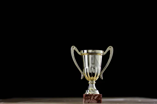 Prize, a cup standing on the table. Cup award on a black backgro — Stock Photo, Image