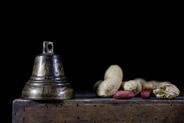 Frutta a guscio in un sacchetto naturale. Un sacchetto di noci e una campana su un vecchio buio w — Foto Stock