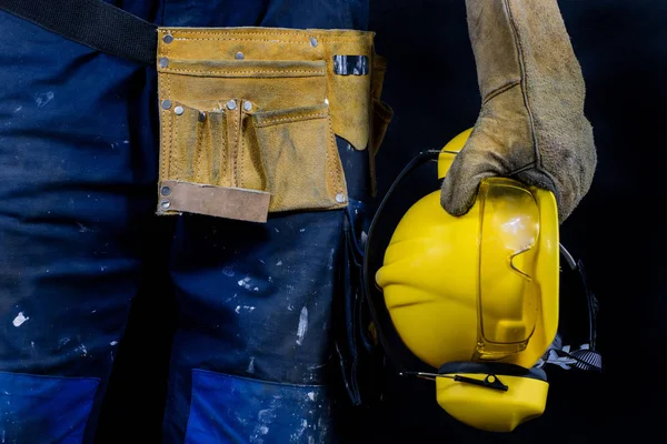 Workwear for production workers. A construction worker holding p