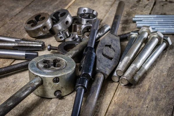 Herramientas metalúrgicas en la mesa del taller. Rosca muere y grifos i — Foto de Stock