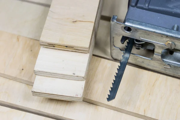 Carpentry tools on a wooden workshop table. Saw and other carpen