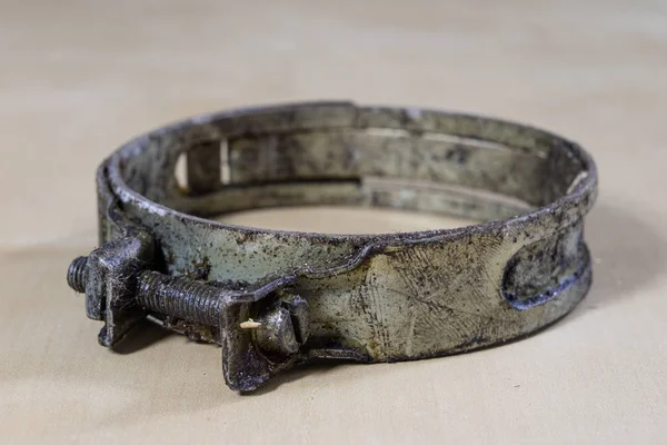 Old garden accessories. Rusty hose clamps on the workshop table.