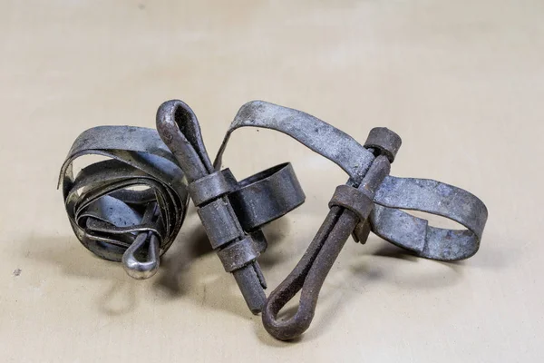 Old garden accessories. Rusty hose clamps on the workshop table.