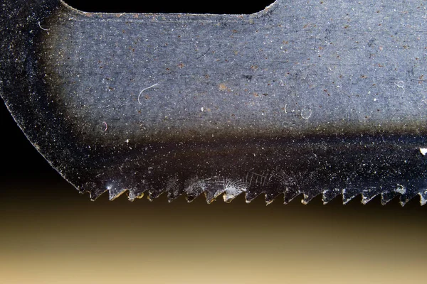 Metal cutting saw under magnification. Hand saw for cutting hard