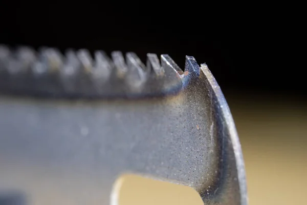 Metal cutting saw under magnification. Hand saw for cutting hard