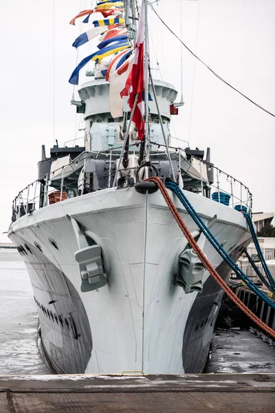 The anchor of a large warship standing in the port. Bow of a shi