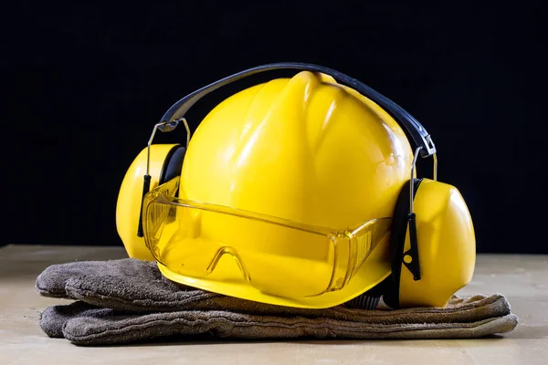 Protective clothing and tools lying on the workshop table. Buy a