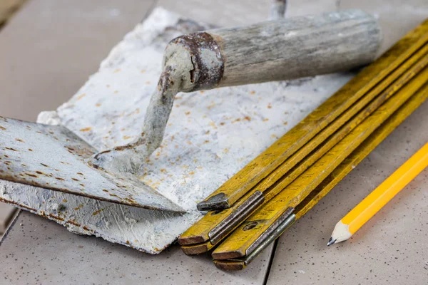 Laying and cutting tiles. Tools and building materials at a work — Stock Photo, Image