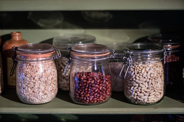 Kitchen supplies on the shelf. Jars with beans in the kitchen pa