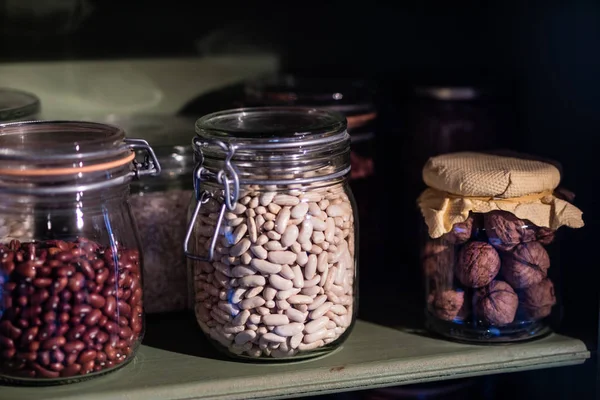 Kitchen supplies on the shelf. Jars with beans in the kitchen pa