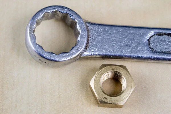 Metric screw and key on a wooden table. Mechanical accessories i — Stock Photo, Image