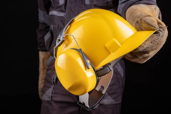 Employee in safety clothing with helmet.