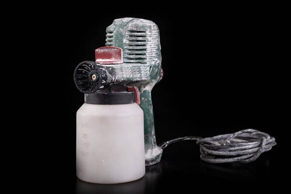 Dirty electric paint sprayer. DIY painting accessories.
