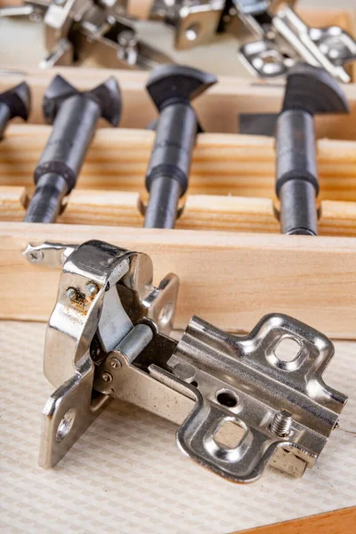 Installation of furniture hinges in the kitchen cabinet door.