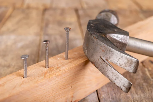 Martillo de carpintero y clavos de acero en una mesa de taller de madera. S —  Fotos de Stock