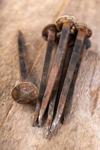 Old rusty nails on a workbench. Steel elements forged in old tec