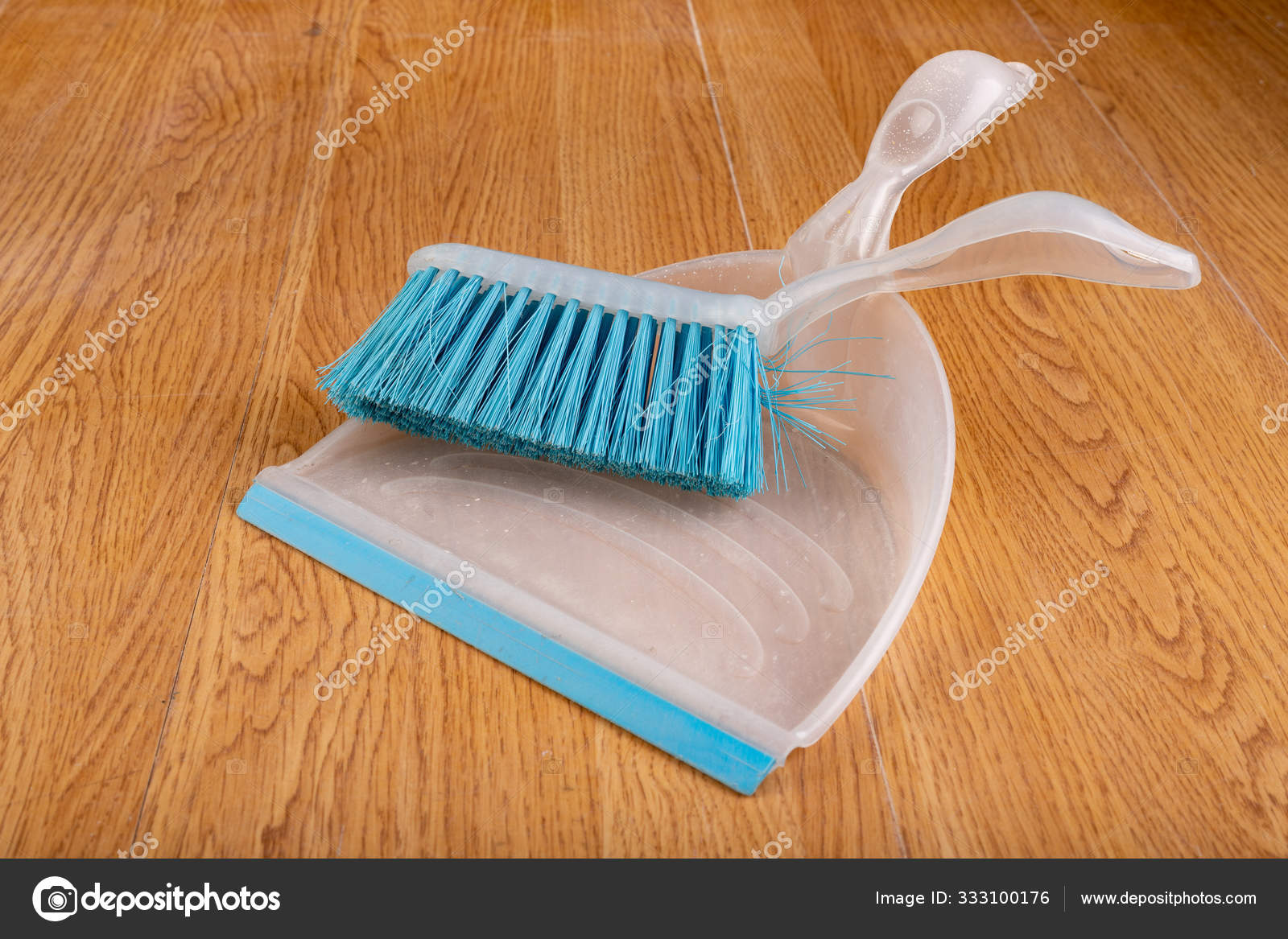 Plastic Dustpan And Brush On A Wooden Floor Cleaning Accessorie