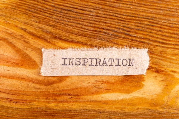The word "inspiration" typed. The inscription on a gray sheet of — Stock Photo, Image