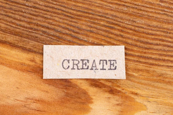 The word "create" typed. The inscription on a gray sheet of papp — 스톡 사진