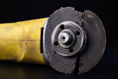 Damaged cutting disc for metal in an angle grinder. Power tools 