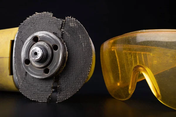 Damaged cutting disc for metal in an angle grinder. Power tools 