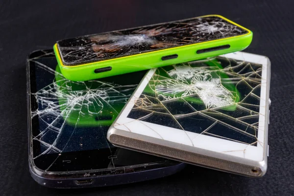 Broken smartphone screen. Broken cell phones.