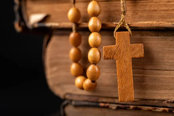 Wooden rosary arranged on an old book. Accessories for prayer in — Stock Photo, Image