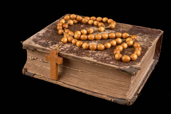 Wooden rosary arranged on an old book. Accessories for prayer in — Stock Photo, Image